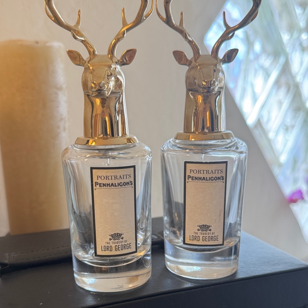 Penhaligon's clear glass fragrance bottles with gold deer caps